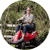 Turf A woman using a riding lawnmower
